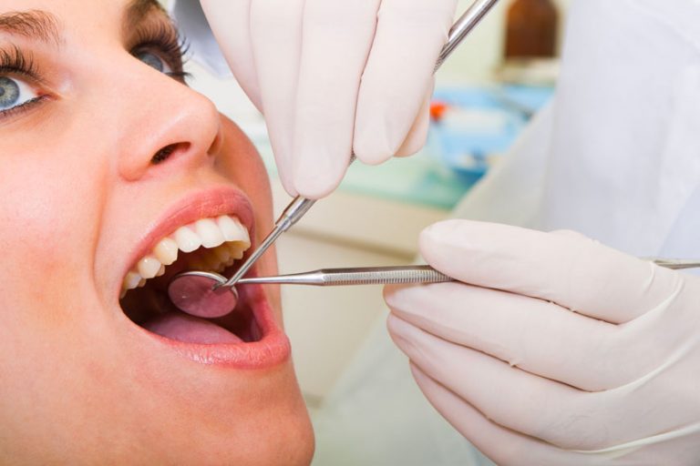 Dentist Examining Women's Teeth