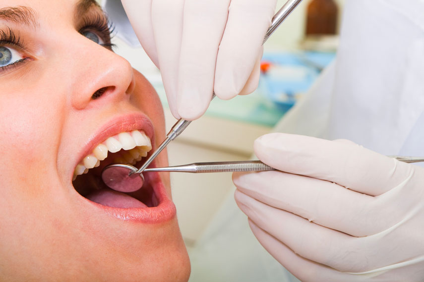 Dentist Examining Women's Teeth