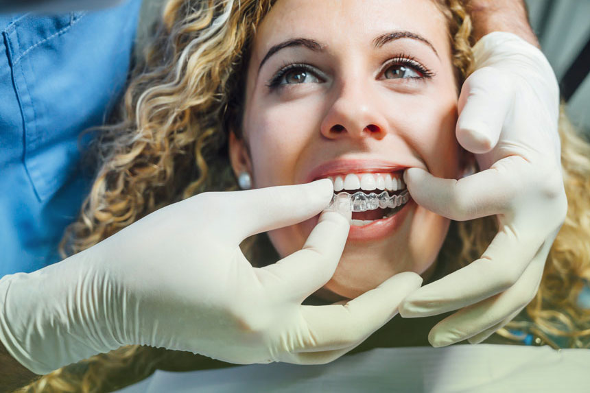 Patient being fitted with clear aligners for orthodontic treatment at Dr. Brent MacDonald’s Calgary dental clinic.