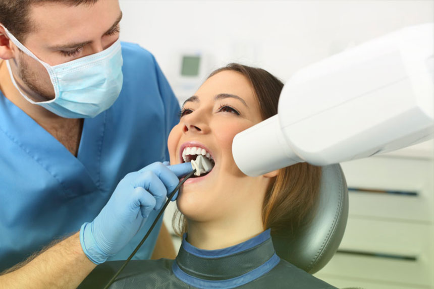 Patient receiving dental X-ray before root canal treatment at Dr. Brent MacDonald’s Calgary dental clinic.