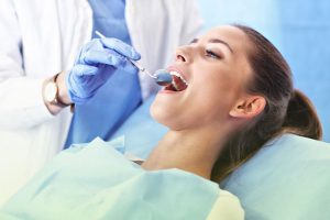 Woman receiving emergency dental care from Dr. Brent MacDonald in Calgary.