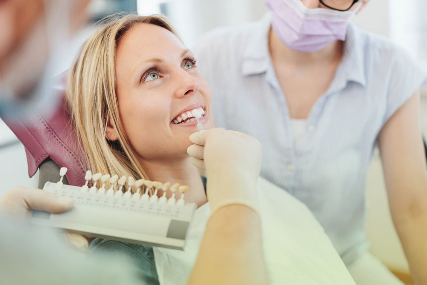 Dentist Demonstrate For Patient Teeth Color Shades Guide For Tooth Whitening