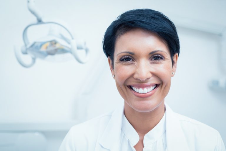 Friendly dentist smiling in a modern dental clinic